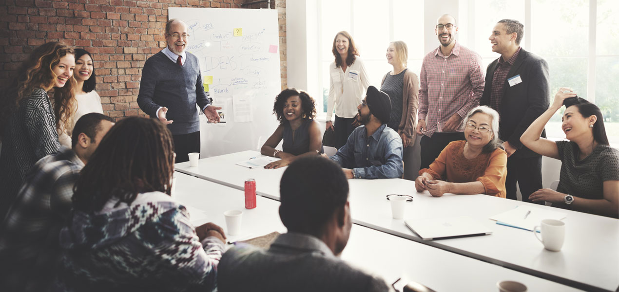 A team gathered in a meeting room and having a discussion.